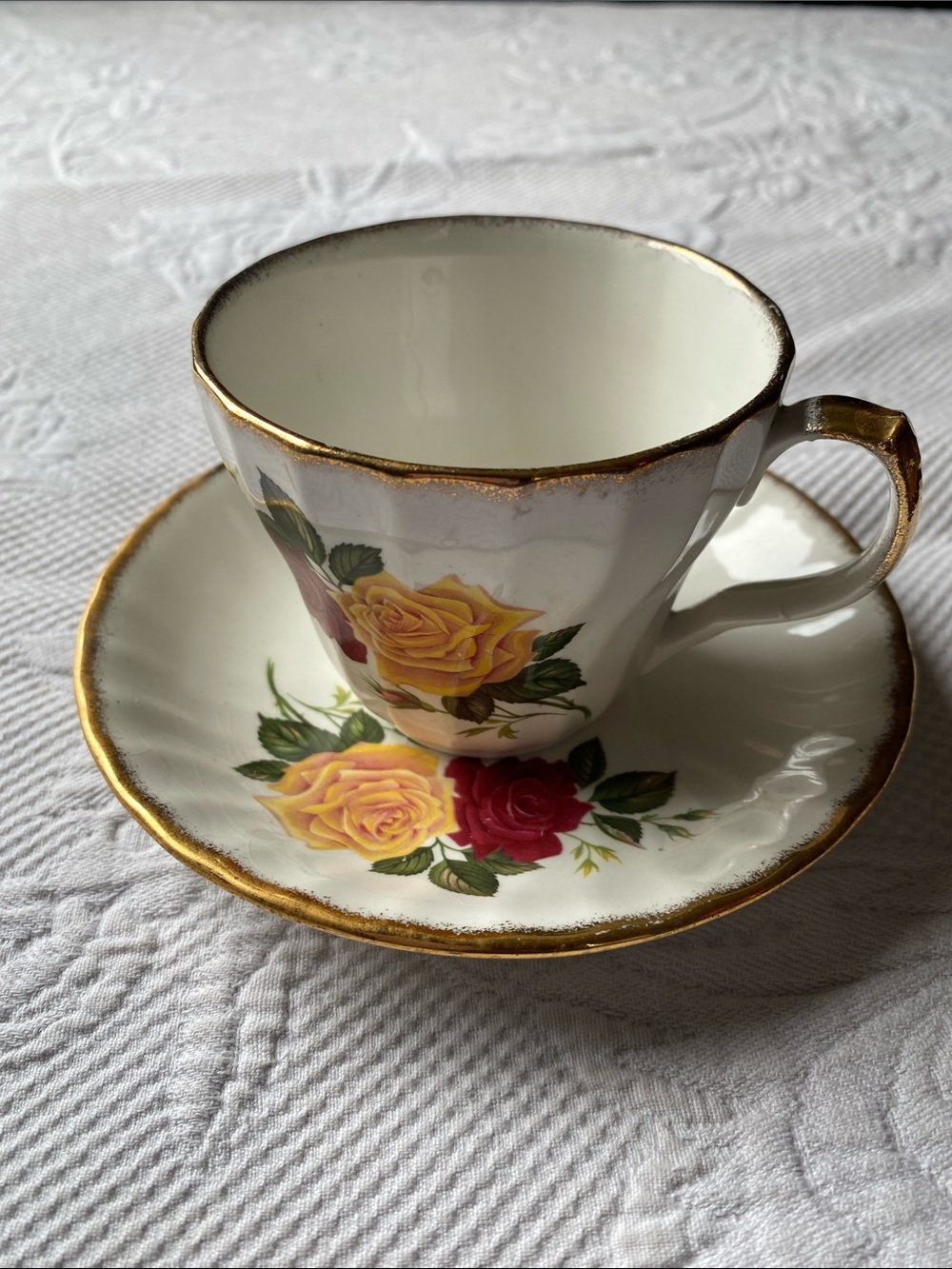 Porcelain Teacup and Saucer with Yellow and Red Rose Design and Gold Trim
